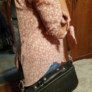 Black purse with top handle and strap, cross body.